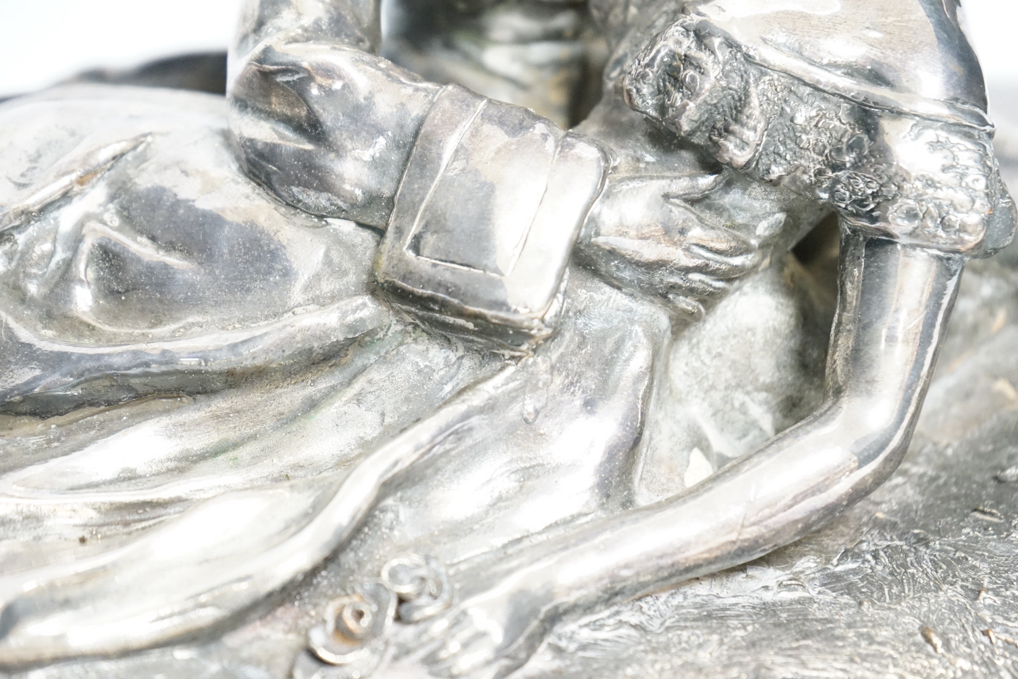 A silvered terracotta figural model of lovers, signed ‘C. Gauci’? and stamped, 49cm